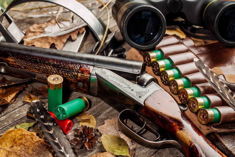 Hunting equipment on the wooden background | coyote hunting rifles