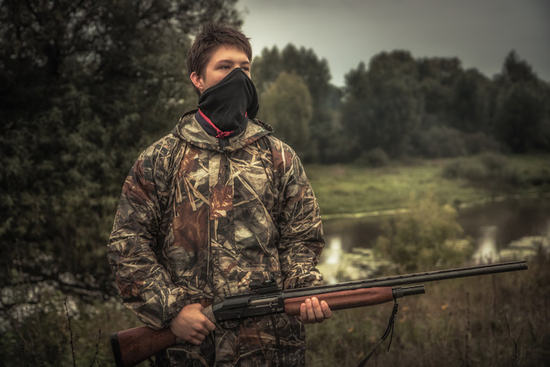 Teenager hunter with face mask and gun during duck hunting season | what do you do with hunted crows