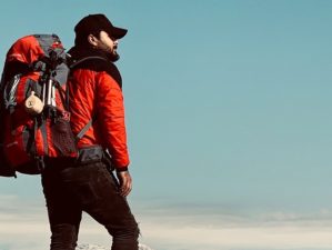 man standing on cliff edge | Ultimate Backpacking Checklist for Beginners | featured