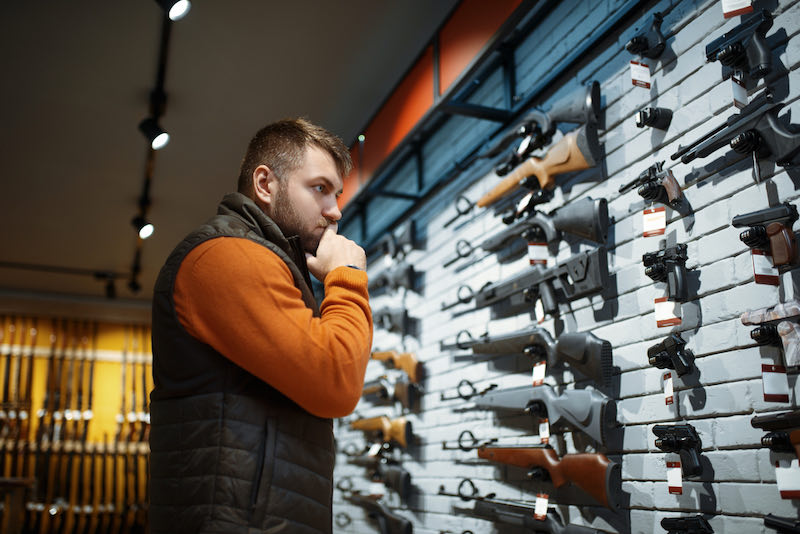 Man looking on handguns | background check