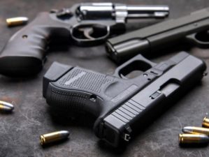 Gun, Pistol with ammunition on wooden background | The Best Handgun Caliber | Featured