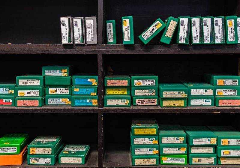Placerville, Half empty shelves of reloading die boxes at a gun shop | Is a 25 Caliber Good for Self Defense?