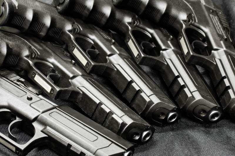 handguns in a row on the black background | Handgun Caliber