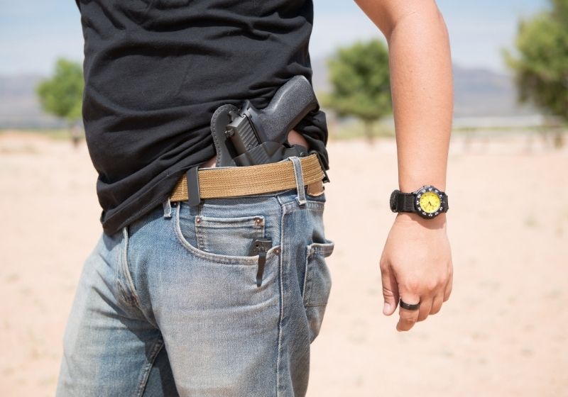 Man with holster pistol in jeans Sig Sauer P365 vs Glock 43 SS