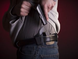 7 Best Concealed Carry Holsters Perfect For Your Gun | A man drawing a conceal carry pistol Best concealed carry holsters | Featured