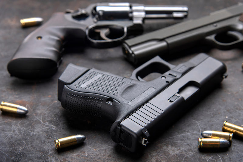 Gun, Pistol with ammunition on wooden background | handgun for beginners