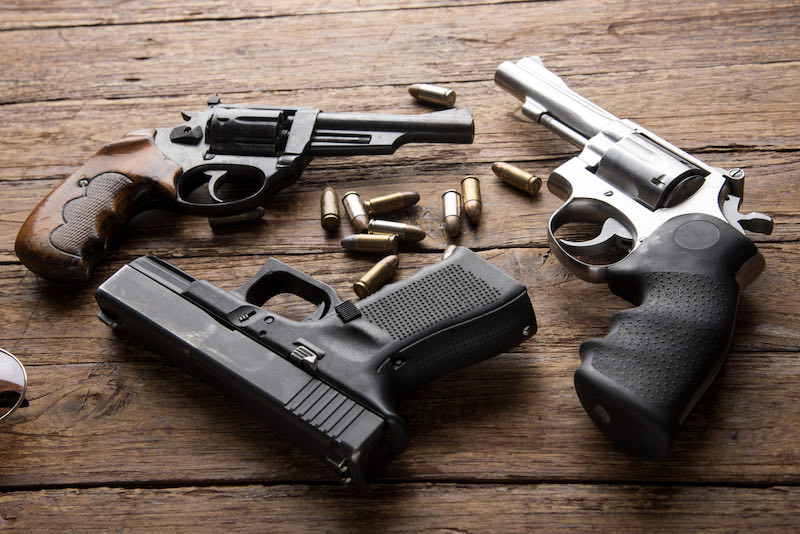 Pile of handguns on wooden table | bersa thunder 380 magazine