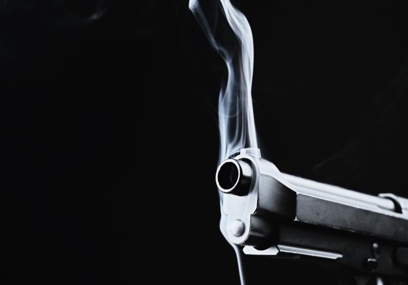 Smoking gun on black background Fn 590 SS
