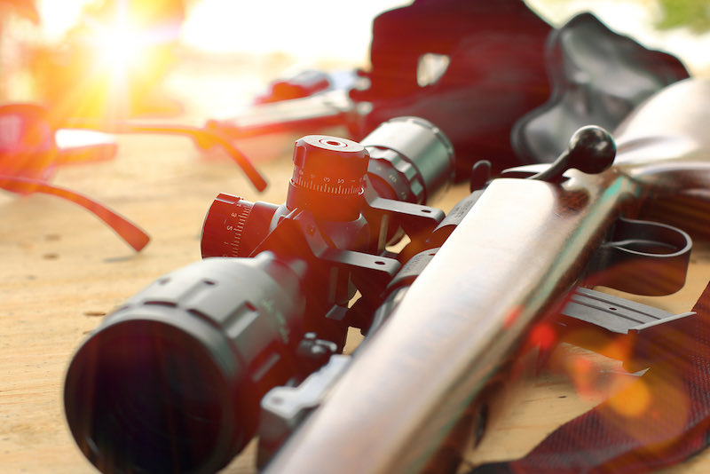 close up of rifle telescope for sport hunting on table wooden | long range shooting classes