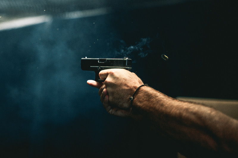 close up on a guy shooting firearm handgun | handgun for beginners