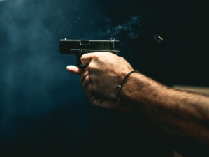 close up on a guy shooting firearm handgun | What's the Difference Between Full-Size, Mid-Size & Compact Pistols | featured