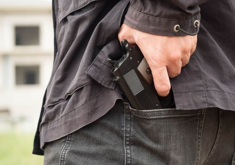 A man policeman or robber gangster concealing Cellphone gun SS