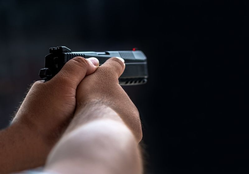 Man aiming pistol in shooting range Cellphone gun SS