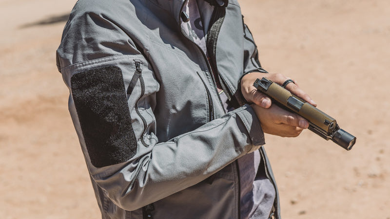 Man showing pistol in desert range close up | smith & wesson m&p spec