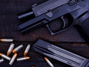 Gun is a dangerous weapon on a black background | Top 5 New Sig Sauer 9mm Handguns 2021 | Featured