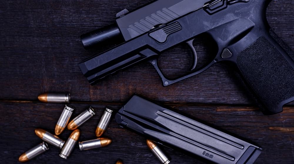 Gun is a dangerous weapon on a black background | Top 5 New Sig Sauer 9mm Handguns 2021 | Featured