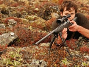 Hunter in alpine tussock aiming rifle | How to aim a rifle | Featured