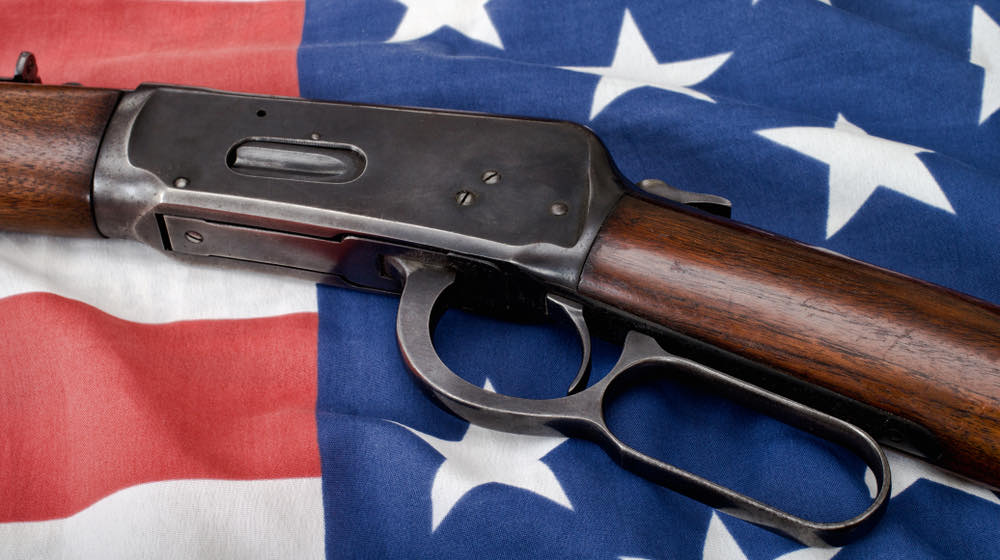 Lever-action rifle and American flag | Top 5 Best Henry Lever Action Rifles For Home Defense and Hunting | featured