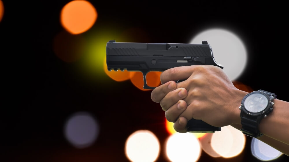 Automatic black 9mm pistol holding in hand aiming | Staccato P Review | Staccato P 1000 Round - The Most Accurate Duty Pistol | Featured