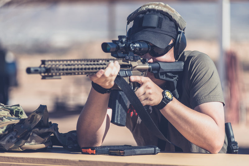 Man shooting assault style rifle | best military surplus rifles