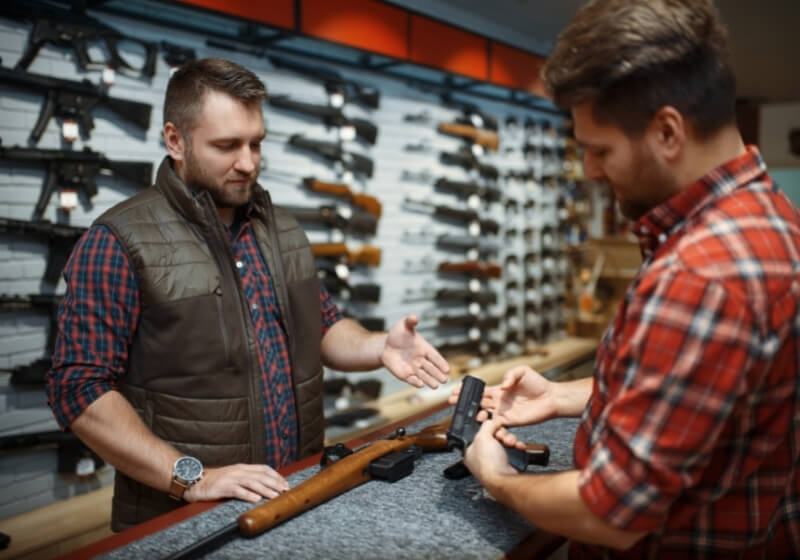 Man with owner choosing handgun in gun shop | staccato p 