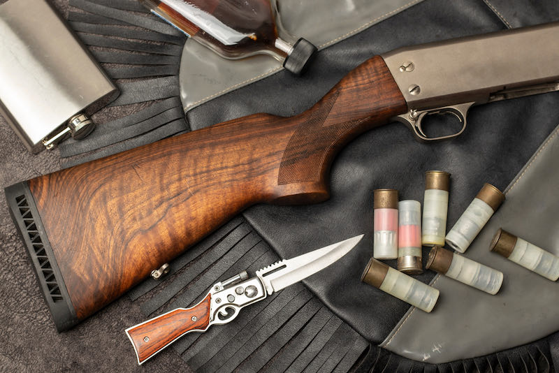 close-up on leather bag walnut wood stock pump shotgun | how to make a sawed off shotgun