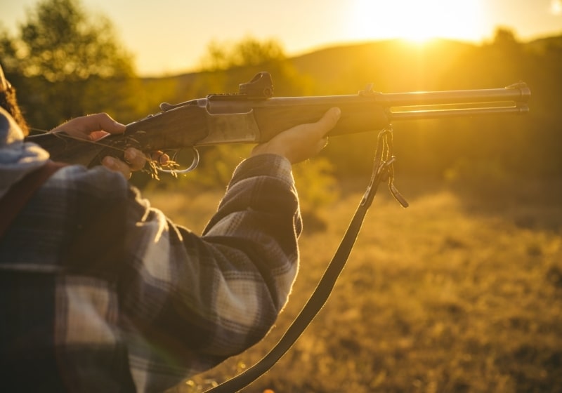 Hunter with shotgun gun on hunt | truck guns