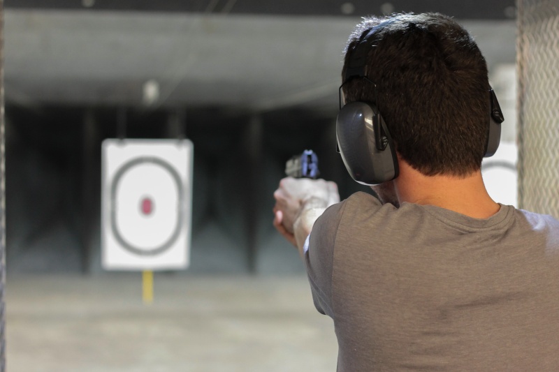 Man Firing Pistol at Target in Indoor Shooting Range | Kimber R7 Mako