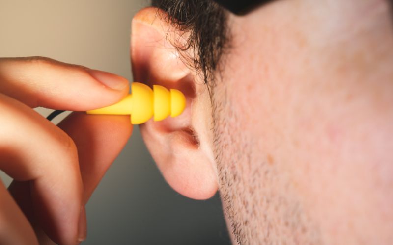 man-worker-inserting-yellow-hearing-safety ISOtunes Sport