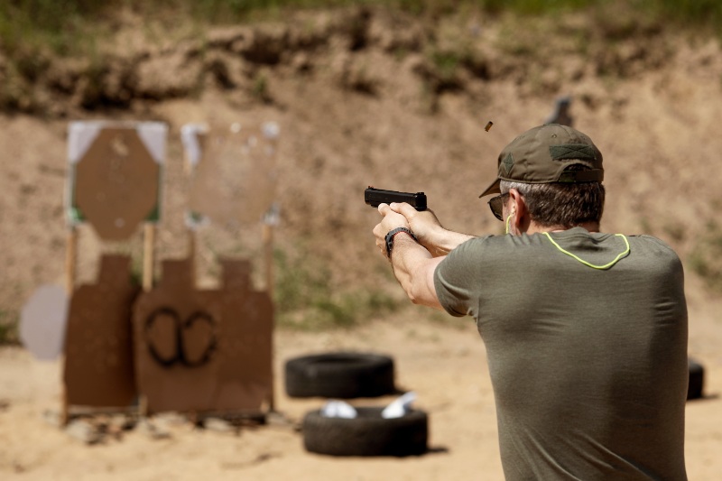 Unrecognisable Man Practising Shooting Pistol at the Shooting Range | Smith & Wesson Model 422