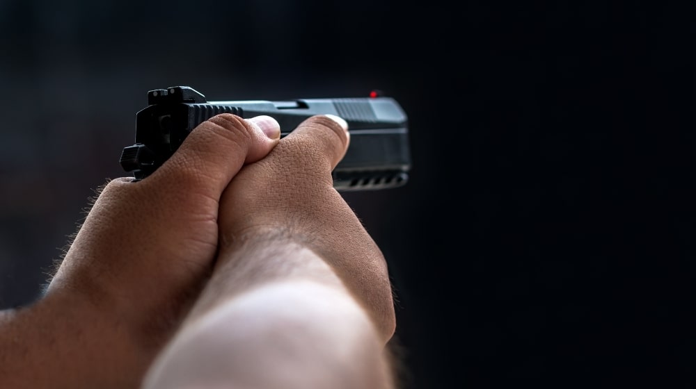 Man aiming pistol in shooting rangeMan aiming pistol in shooting range | Top 10 CZ Guns For 2022 | Featured