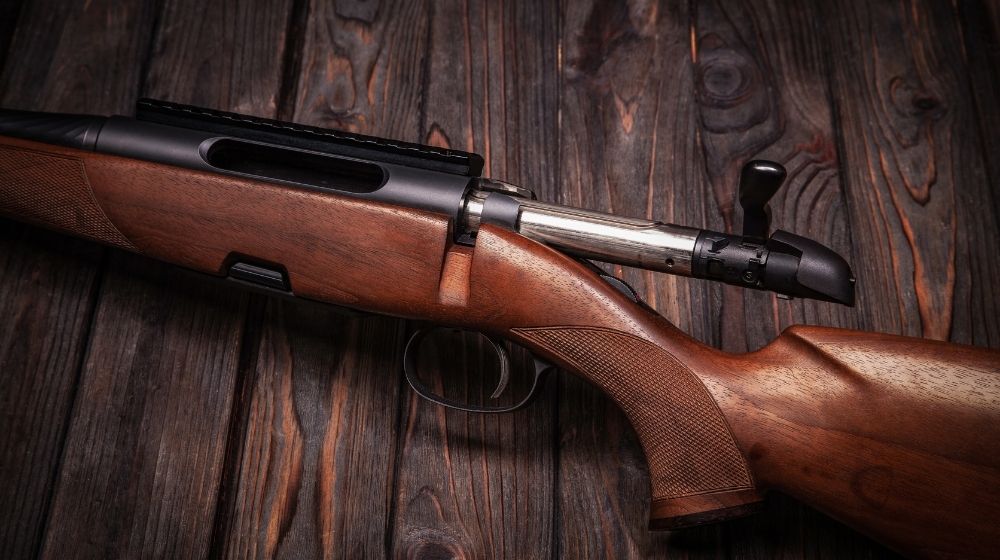 Rifle with a wooden stock on a dark background | Top 10 Best 357 Magnum Lever Action Rifles | Featured