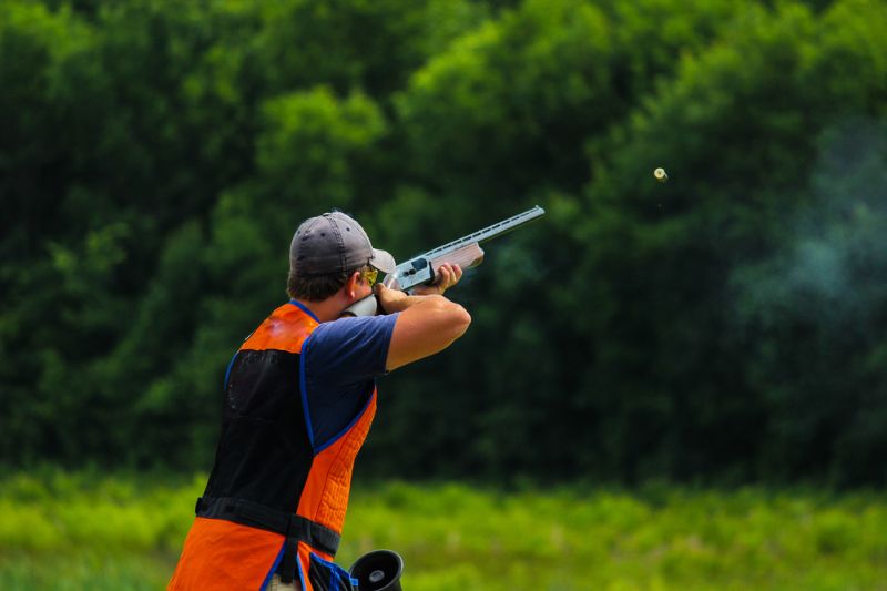 young-man-skeet-shooting-outdoors-clay Skeet Shooting