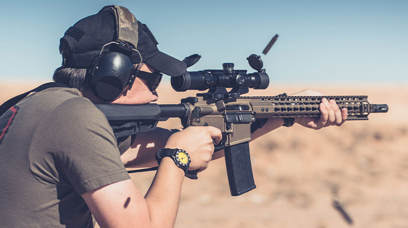 Man on desert range shooting assault rifle standing from behind | ATF Stabilizing Braces | ATF Pistol Brace