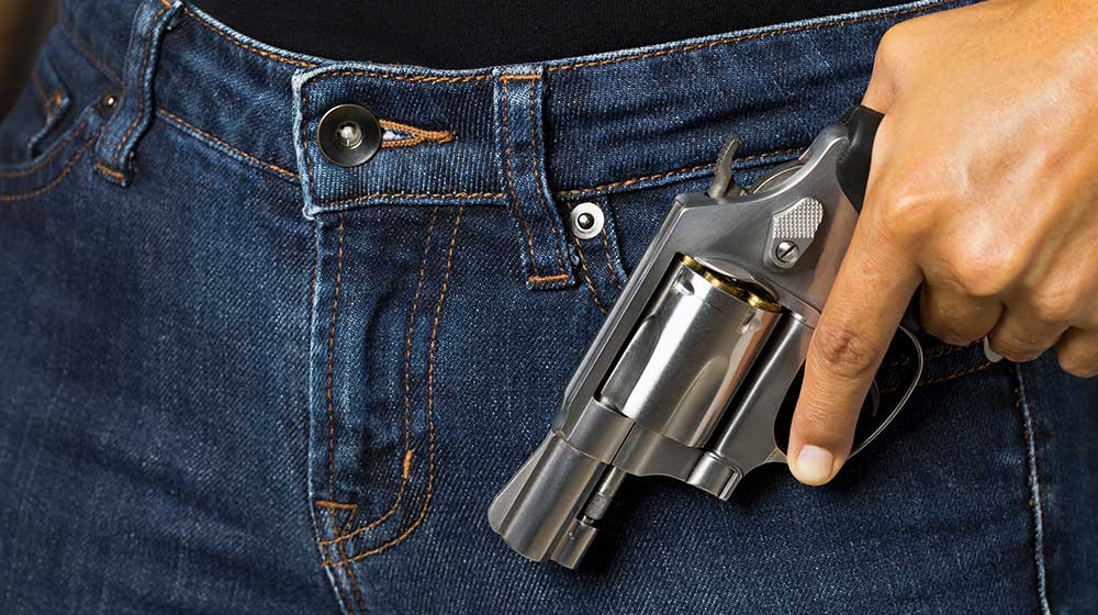 Woman is holding a revolver gun in her hand | Top 9 Best Pocket Pistol for Concealed Carry | Featured