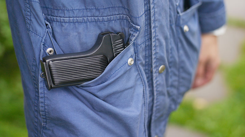 Closeup of a man standing with a firearm in pocket | Top 9 Best Pocket Pistol for Concealed Carry | best pocket pistol 