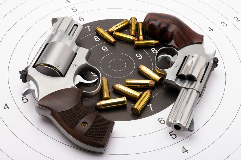 Revolver Handgun Pistols and Bullets on Bullseye Target Background | 44 Magnum Revolver