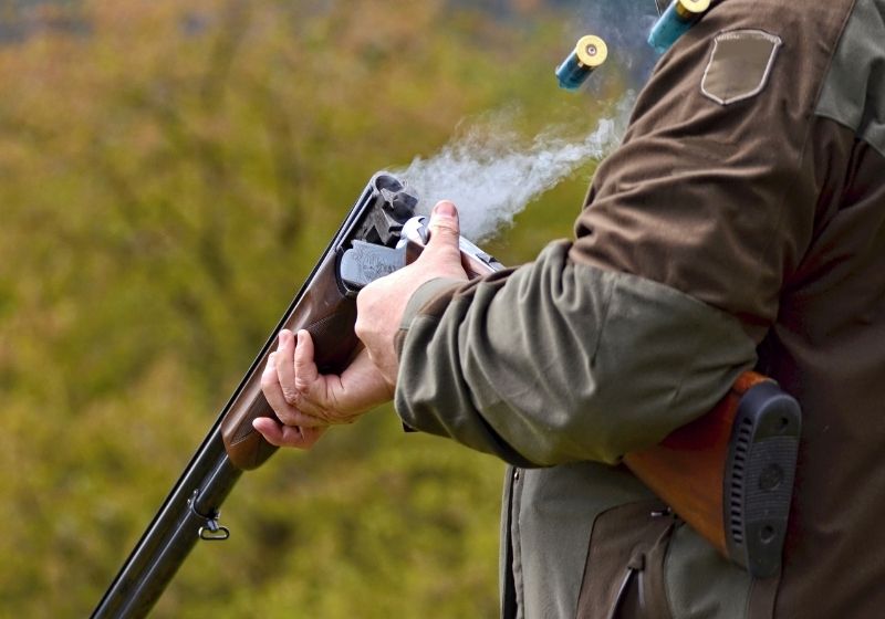 Gunman with smoking shotgun after a shot | What Should You Check Before Choosing a Firearm for Hunting