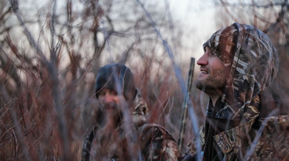 Two men inside forest | What Should You Check Before Choosing a Firearm for Hunting | Featured