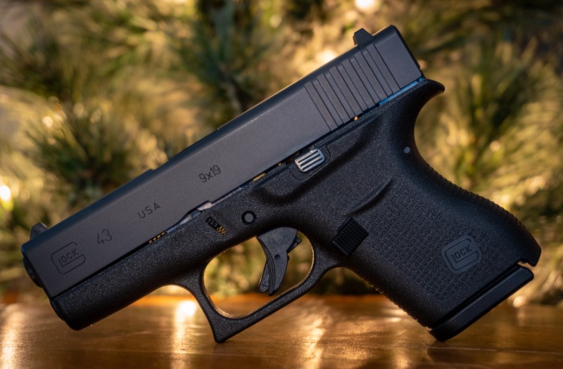 Glock 43 Pistol with Tree Background on Wooden Surface | Glocks for Women