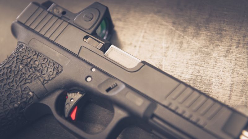 ustom-handgun-laying-on-table-close Red Dot Pistol