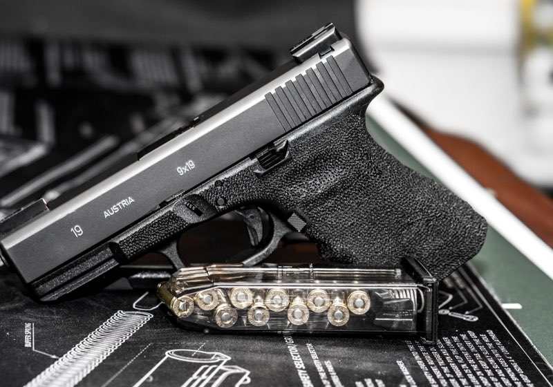 Glock 19 handgun with green night sights, clear magazine with bullets inside | Glock Improvements
