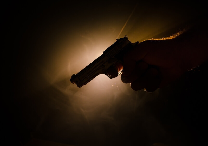 Male hand holding gun on black background with smoke | 5 Top Hand Guns that are Worth More than Your Tax Money