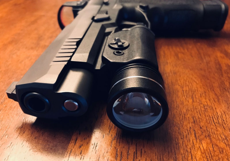 semi-automatic handgun with light and sight on a table | Avoid These 5 Glock Upgrades (and 5 To Try Instead!) | Glock upgrades