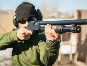 young man on tactical gun | Top 7 Best Tactical Shotguns 2022