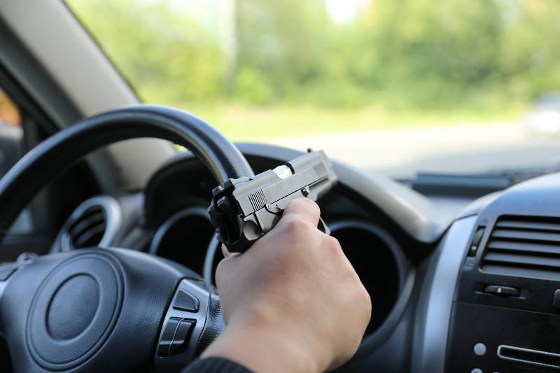 Man driving a car with a weapon | Travelling with Firearms