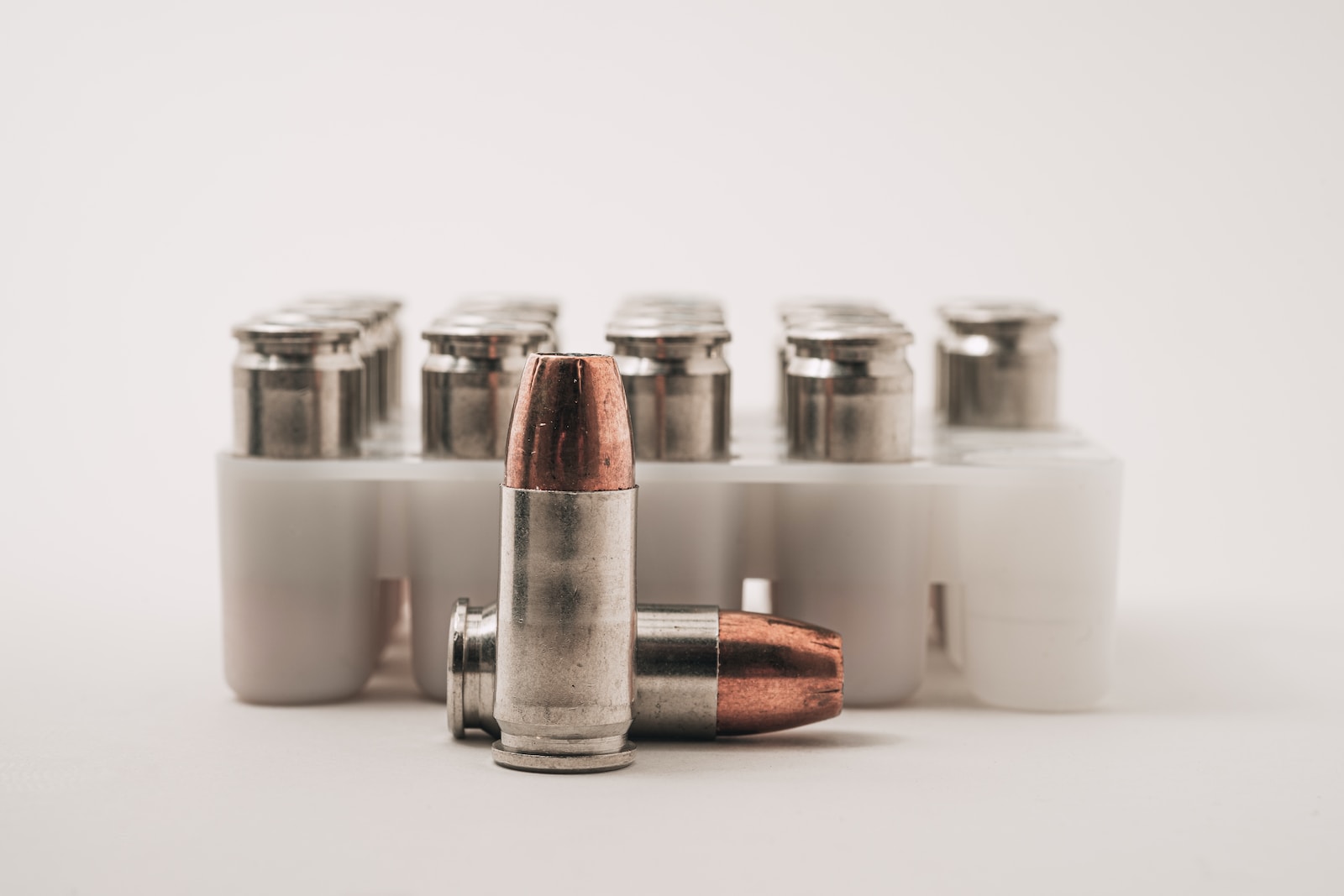 9mm vs 45 Caliber white and brown bottles on white table
