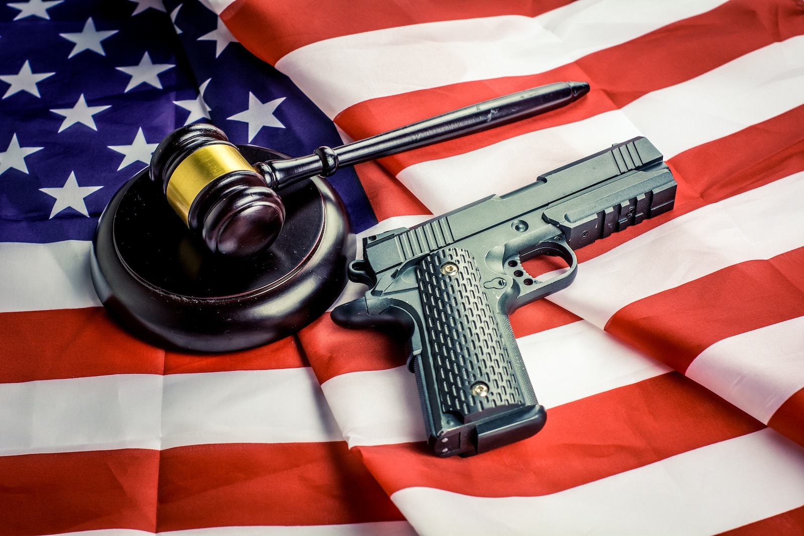 Best Law Enforcement Handguns a gun, a judge's hammer, and an american flag
