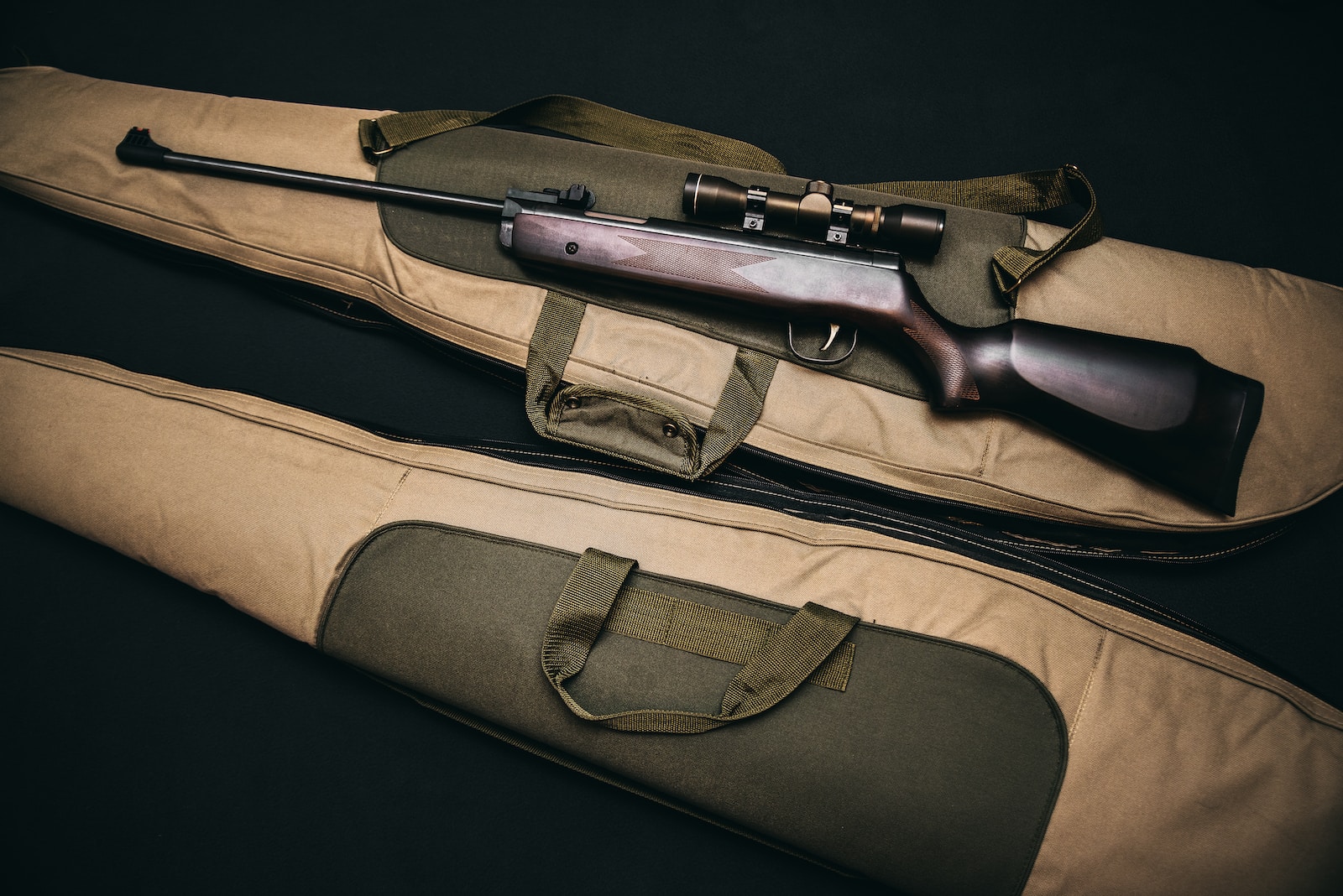 best rifle scopes - brown and black sniper rifle with beige bag
