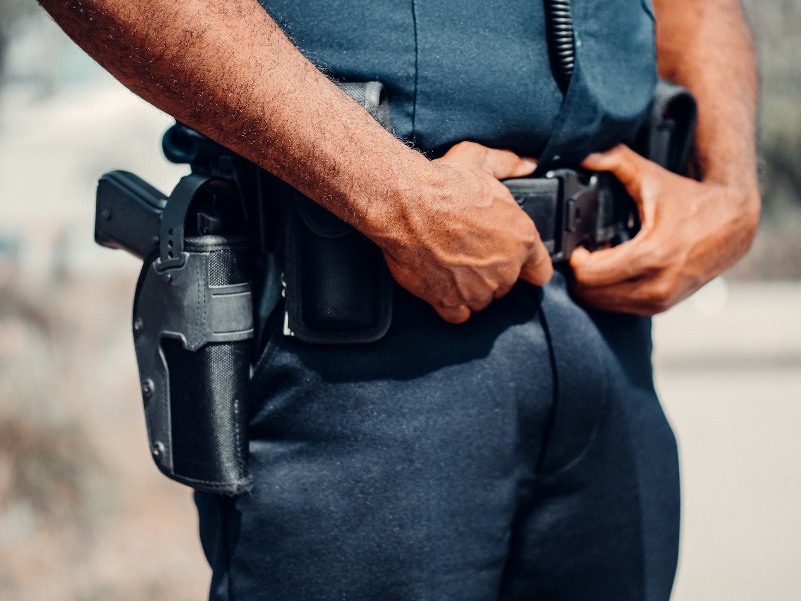 Holsters Police Officer in Blue Uniform with Handgun